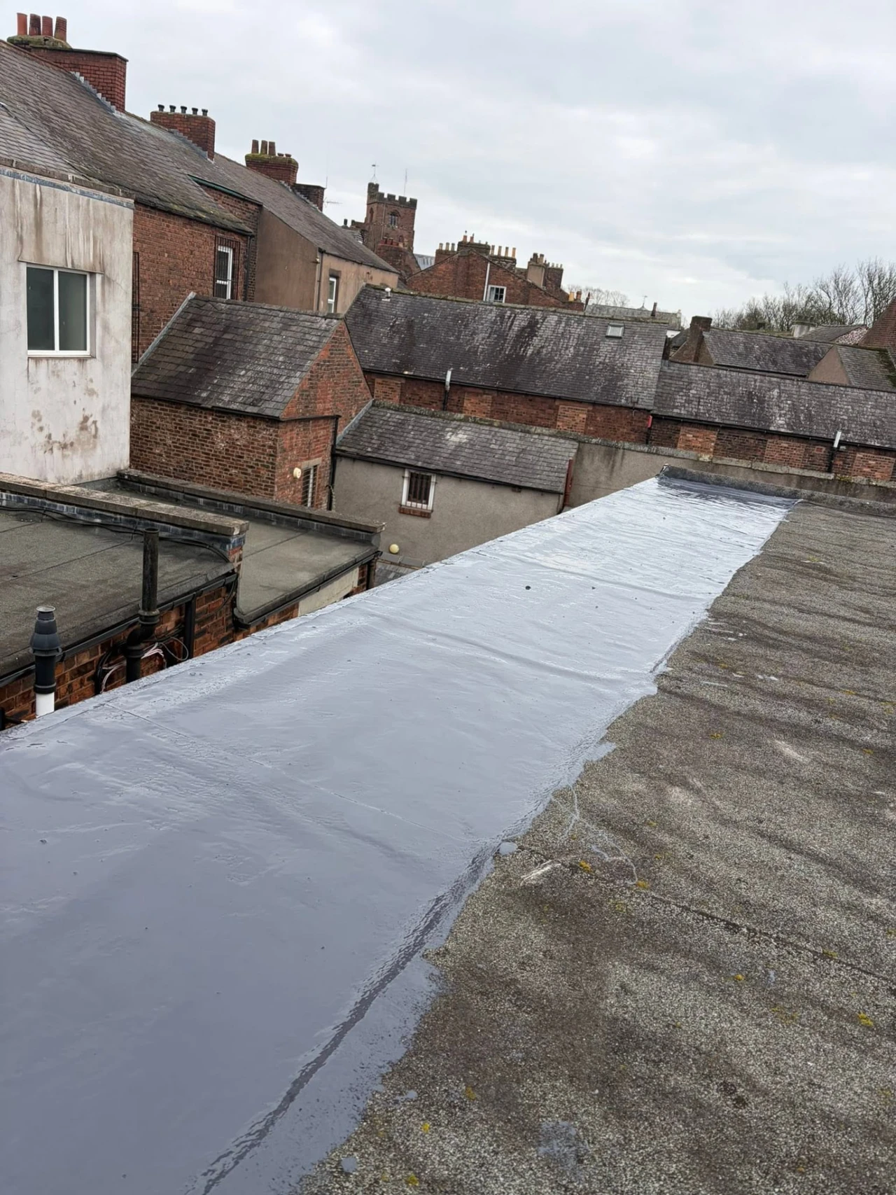 Flat roof area with surface treatment in progress